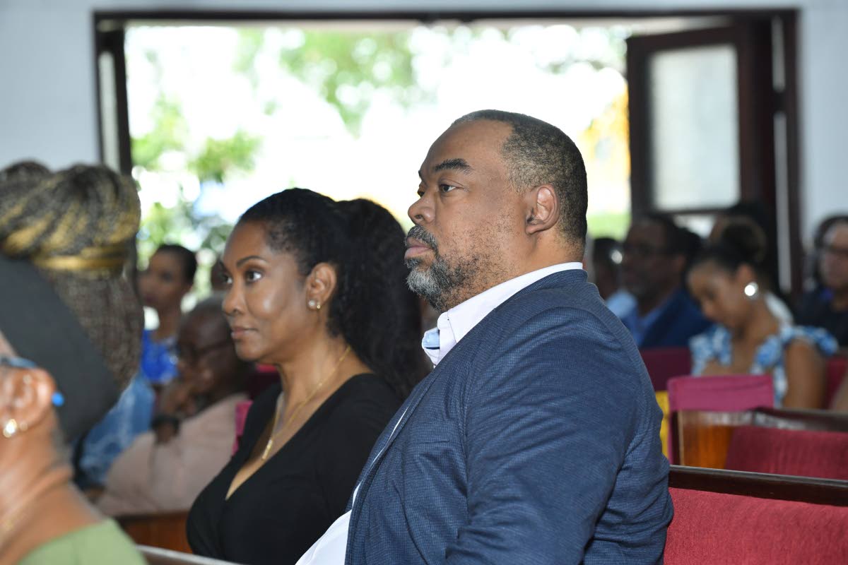 Mayberry Group CEO Gary Peart (right) and wife Cheryl Peart (left) during the funeral for Doris ‘May’ Berry, founding director of Mayberry Investments Limited, at Webster Memorial United Church on Monday.