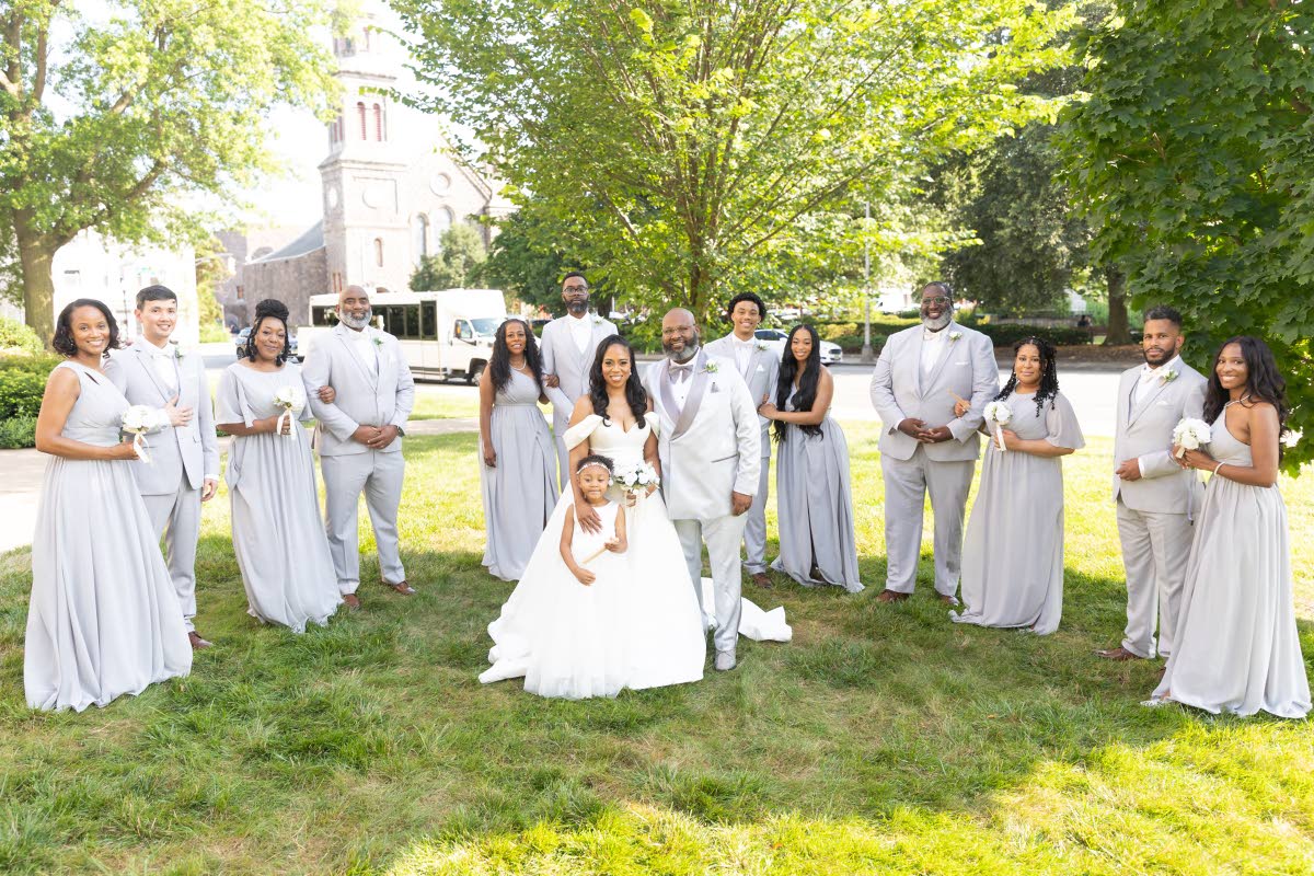 Newlyweds Michael and Yvonne Grant and daughter Nuri Rawles, the flower girl and bride’s attendant, share lenses with their bridal party and family members. 