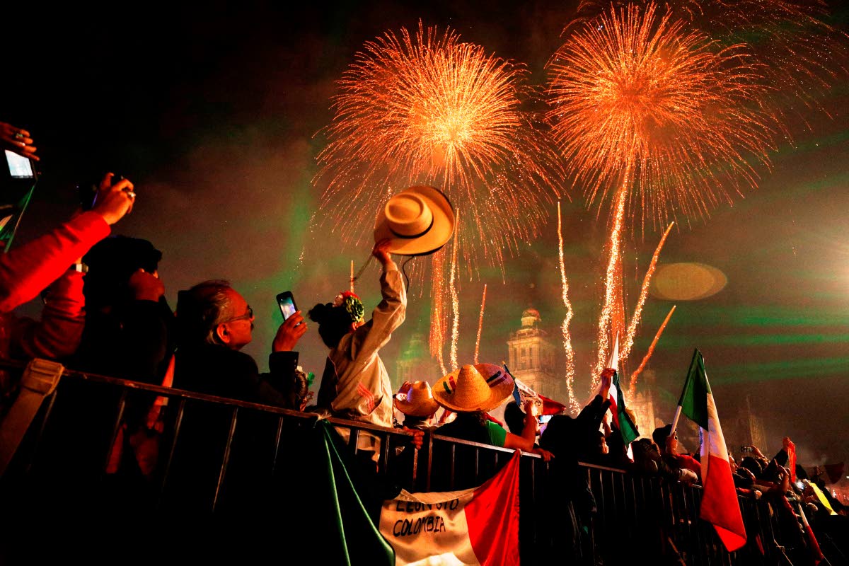 In this 2019 photo, revellers celebrate as fireworks explode over the Metropolitan Cathedral after then president Andrés Manuel López Obrador gave the annual independence shout from the balcony of the National Palace to kick off Independence Day celebrat