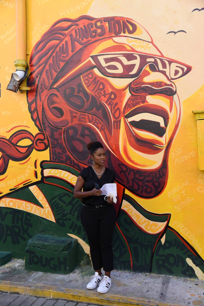 Andrea Dempster Chung, co-founder and managing director of Kingston Creative, stands in front of a mural of Frederick ‘Toots’ Hibbert on Water Lane in downtown Kingston on November 25, 2020. Hibbert, who rode a wave of fame for more than five decades a