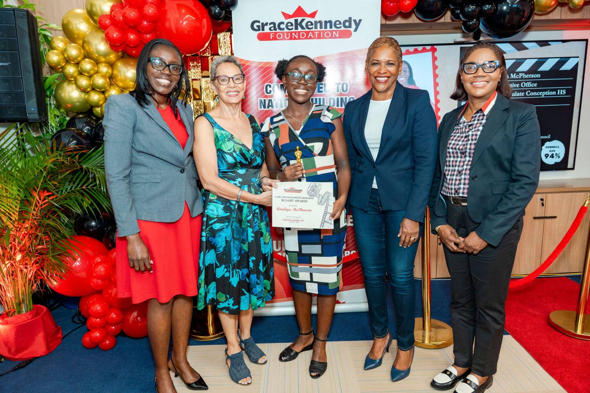 Grade 10 student at Immaculate Conception High School, Ameliya McPherson (centre), accepts her Carlton Alexander Memorial Bursary from Professor Julie Meeks-Gardner, chair of the GraceKennedy Foundation, during the awards ceremony held on August 29. Sharin