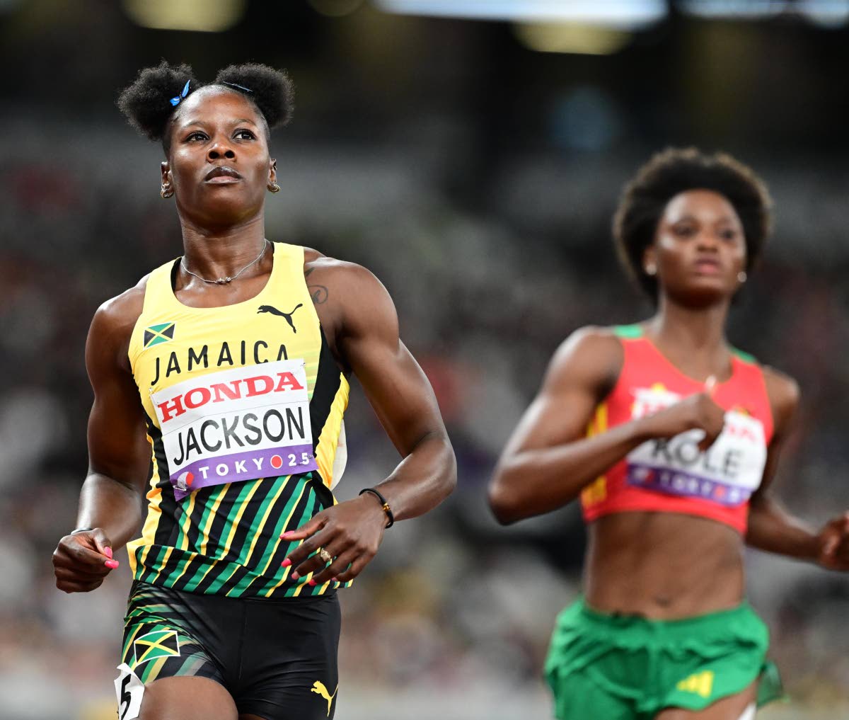 Shericka Jackson (left) cruises during her 100-metre at the World Athletics Championships inside the Japan National Stadium in Tokyo yesterday.