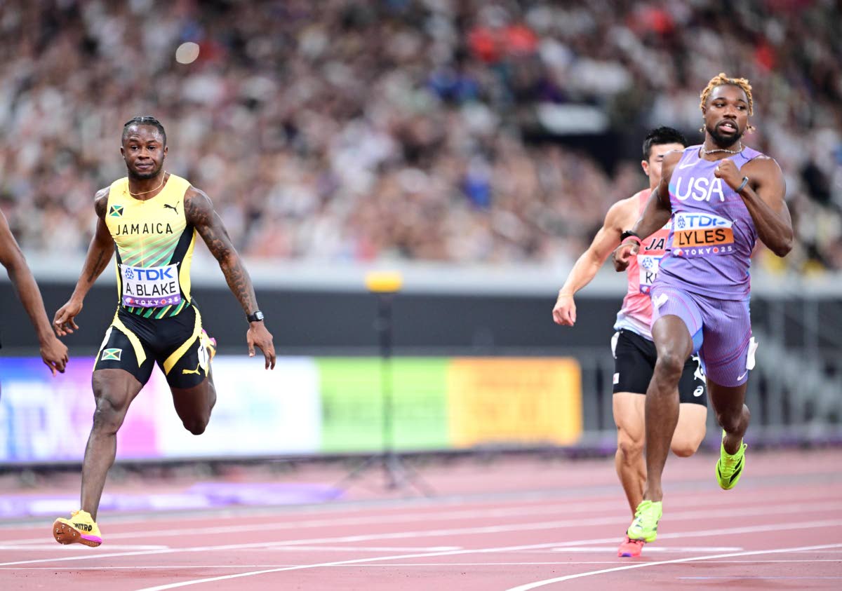 Jamaica’s Ackeem Blake (left) and the United States’ Noah Lyles come through the tape in a 100-metre heat at the World Athletics Championships inside the Japan National Stadium yesterday.