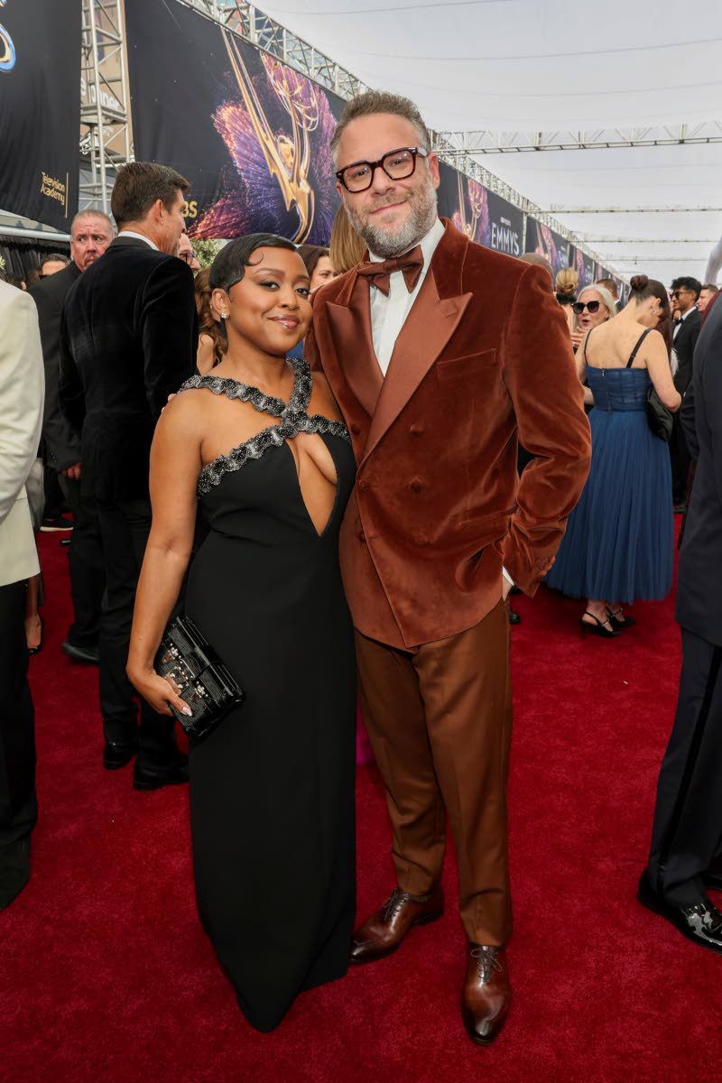 Quinta Brunson (left) and Seth Rogen walk the red carpet at the 77th Emmy Awards, Brunson in Louis Vuitton and Rogen in custom Etro.