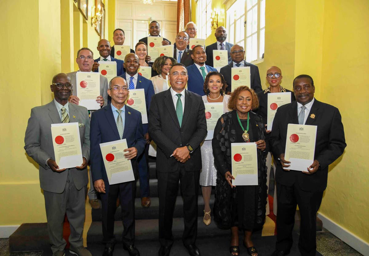 The prime minister and members of his cabinet pose for a photo: In front row (from left) are: Desmond McKenzie; Dr. Horace Chang; Prime Minister Dr Andrew Holness; Olivia Grange; Robert Montague. Second row: Daryl Vaz; Pearnel Charles Jr; Audrey Marks; Dan