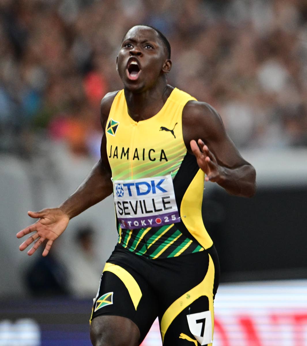 Jamaica’s Oblique Seville celebrates after crossing the finish line in first place, mining gold and claiming the World Champion title in the men’s 100m on Sunday.