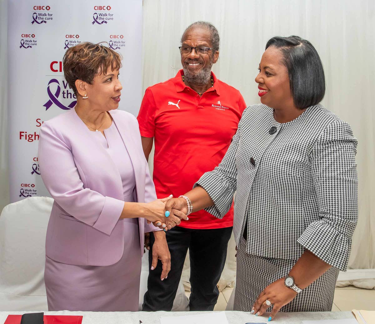  CIBC Caribbean’s Head of Country Annique Dawkins (left) greets Roshane Reid Koomson, executive director of the Jamaica Cancer Society (JCS) at the launch of the 14th annual CIBC Caribbean Walk for the Cure. Looking on is Alfred ‘Frano’ Francis, ma