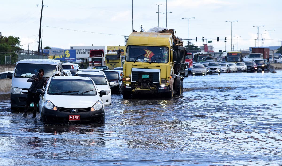 In this 2020 photo a taxi is seen stuck on a flooded section of Marcus Garvey drive in the vicinity of the Tinson Pen Aerodrome.