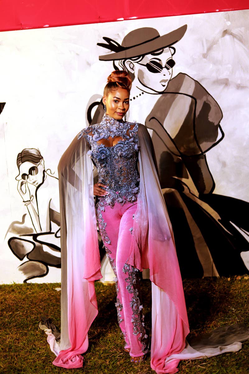 The model, singer and songwriter stuns in this jumpsuit with light pink and silver details, designed by Uzuri International. 