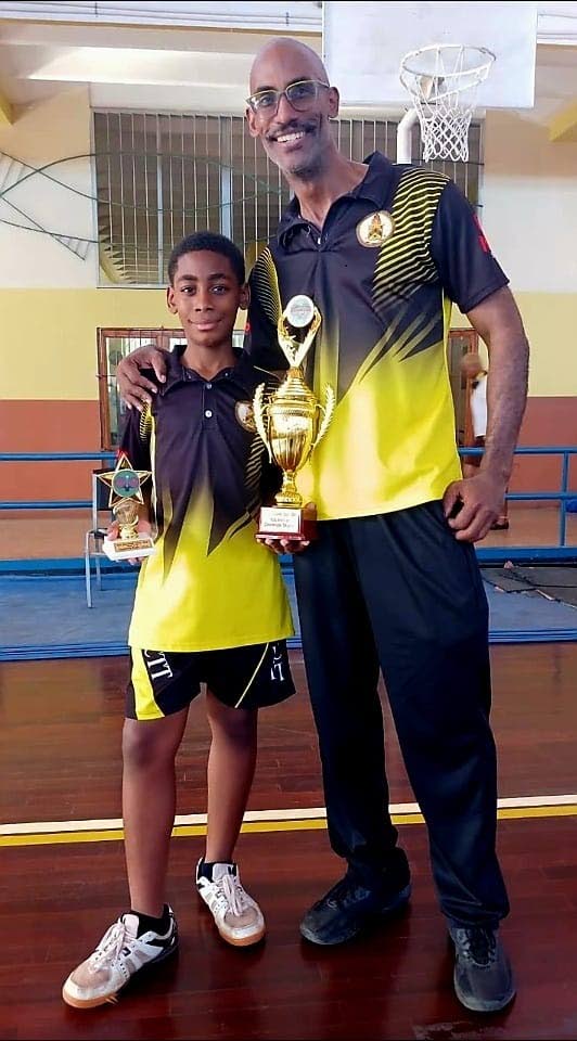Michael Fletcher and his father, Cary, celebrate York Castle High School’s historic victory at the ISSA Rural Championship earlier this year.