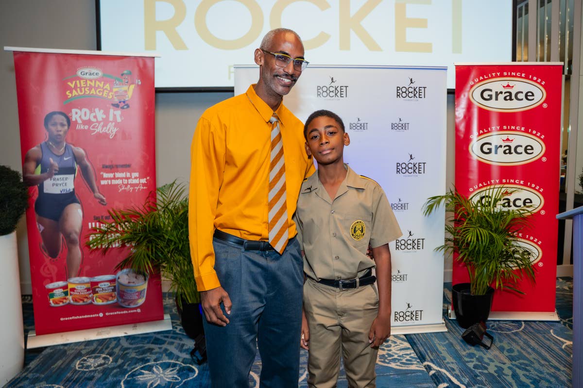 It’s a proud moment as young Michael draws close to his dad Cary Fletcher at the recently held Pocket Rocket Foundation Scholarship Awards Ceremony.