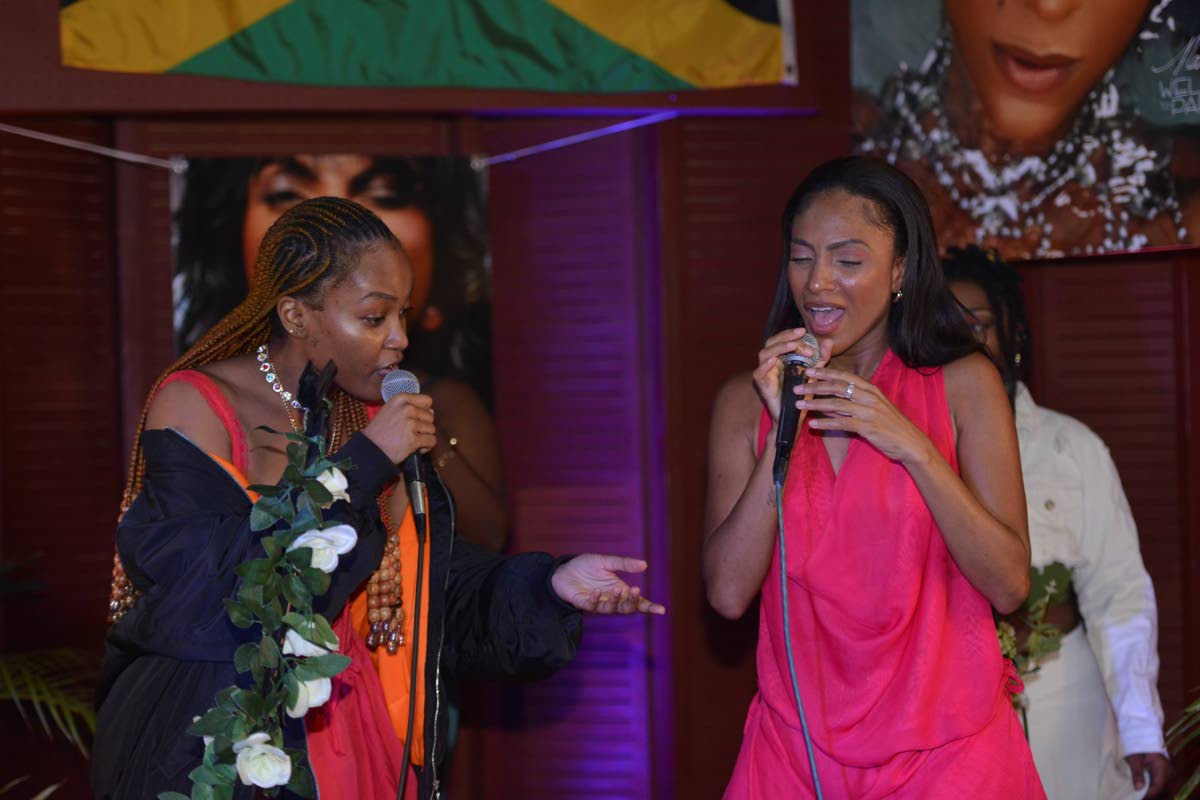 Reggae singer Jaz Elise (left) joins Cowan onstage for an impromptu duet.