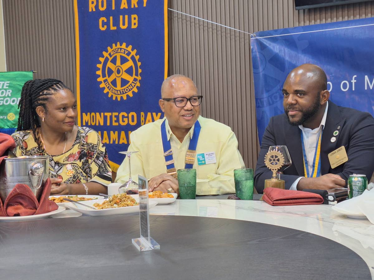 From left: Rotarian Dr Ella Aiken, wife of  District Governor, Professor William ‘Bill’ Aiken (centre), and Lemar James, president, listen keenly to Aiken’s presentation on cardiovascular disease at the Rotary Club of Montego Bay’s weekly meeting. 