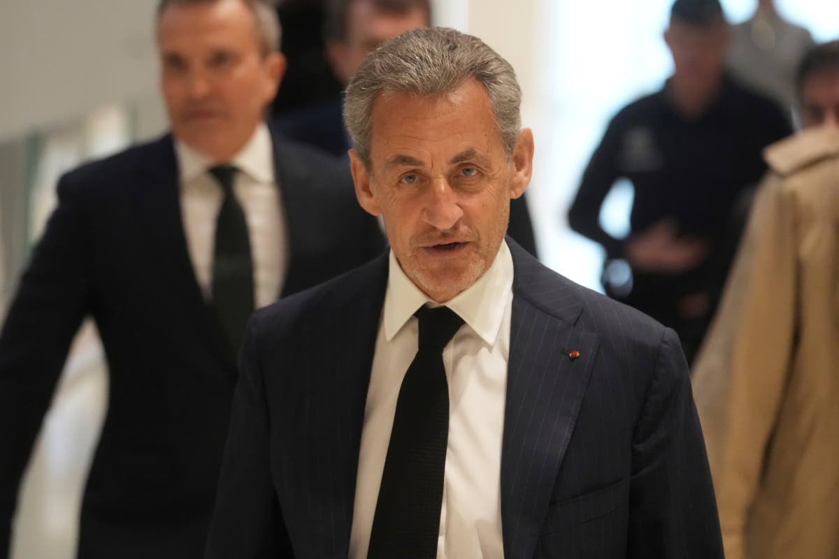 Former French President Nicolas Sarkozy arrives as he goes on trial over alleged illegal financing of his 2007 presidential campaign by the government of late Libyan leader Muammar Gaddafi.