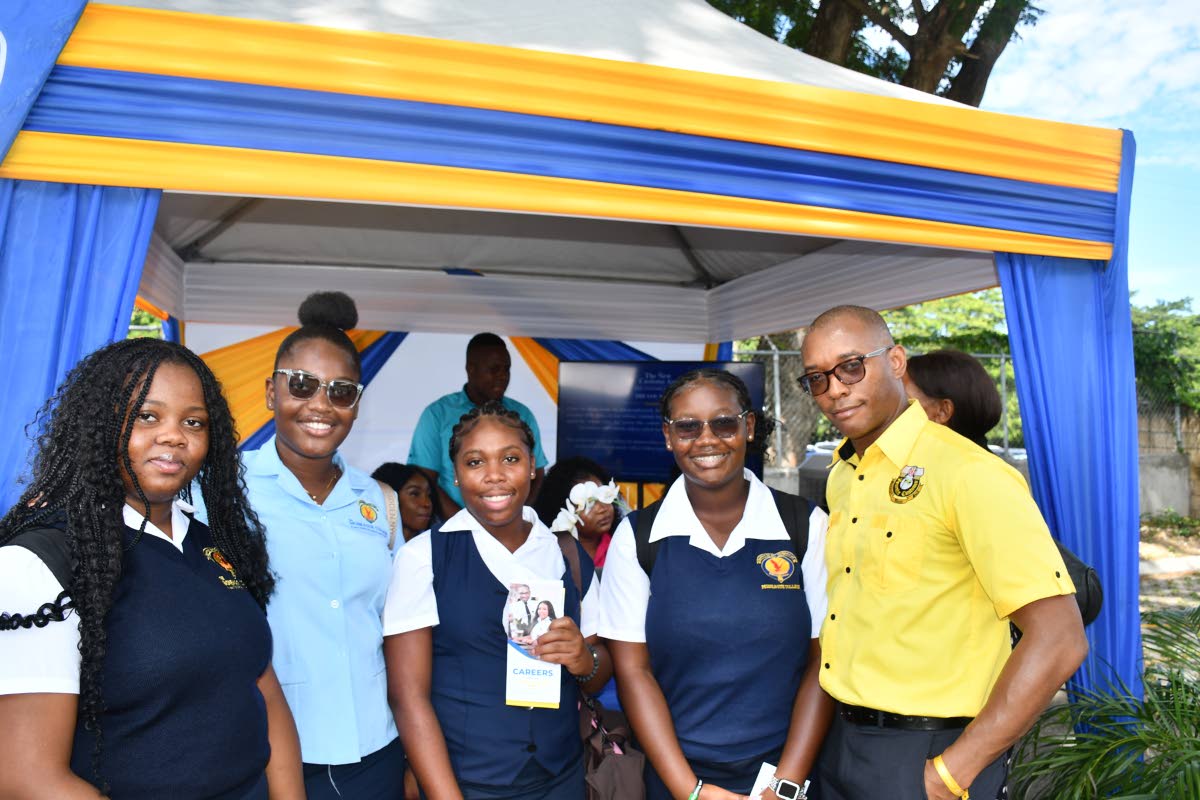 Data Protection Officer Desmond Pringle (right) shares in a quick picture with students from Moneague College at the Court Administration Division’s Public Education Day Symposium.