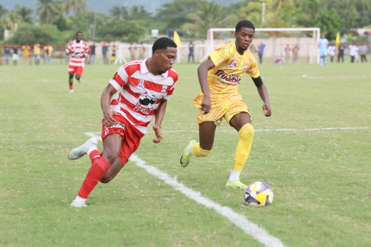 Garvey Maceo High’s Tyreek McKenley (right) challenges Orel Miller of Glenmuir High during their recent Zone I, daCosta match at Glenmuir. Garvey Maceo came from behind to win 3-2. 