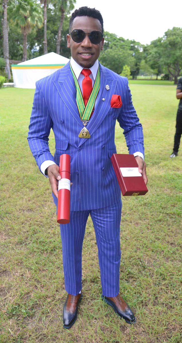 Retired Olympian and the second fastest man in history, Yohan Blake, looks sharp in a blue pinstripe double-breasted suit as he is conferred with the Order of Distinction in the rank of Commander for his outstanding contributions to track and field and phi