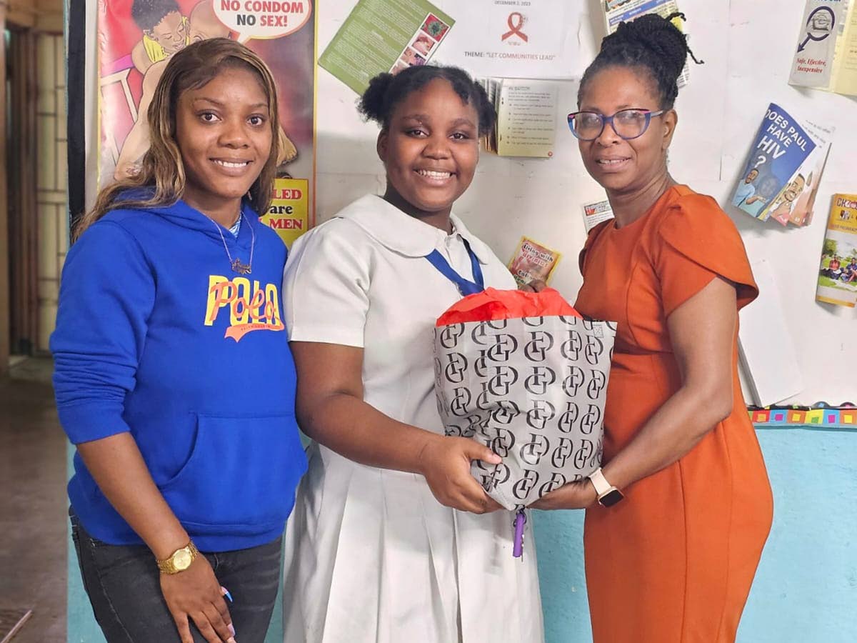 Marymount High School’s Vice-Principal Mrs Renee Lawrence (right) handing out a grocery basket to one of 17 families, during the Holiday Helpers’ annual treat in 2023.