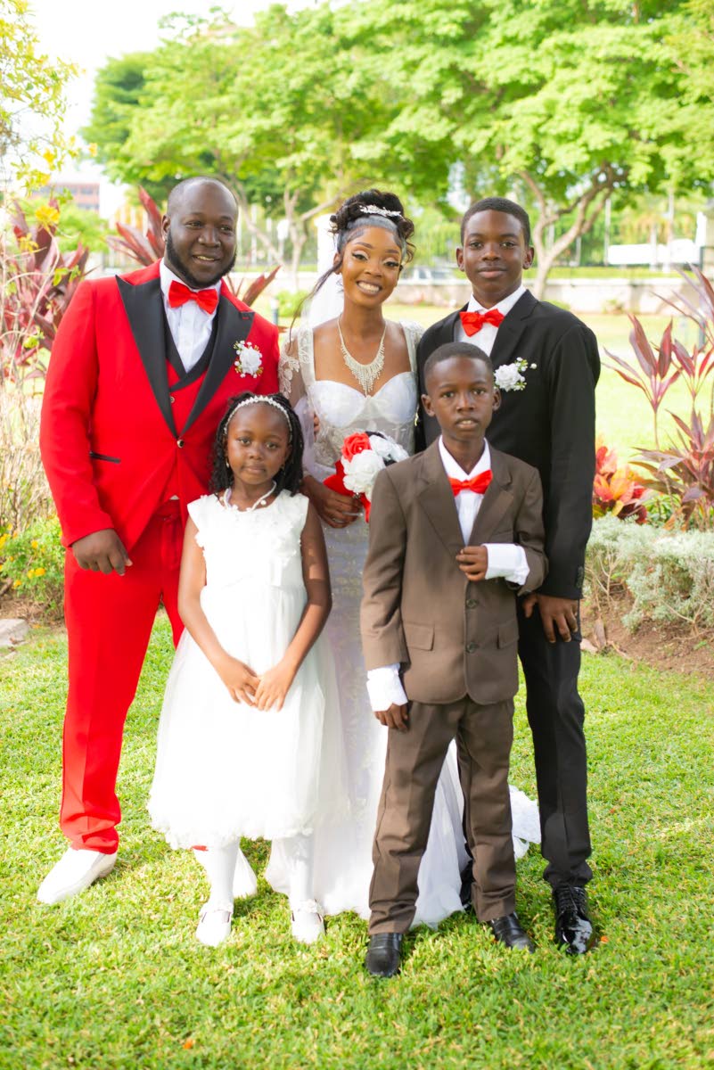 Officially one big happy family, Delroy Madden (left) poses with his wife Samantha, her children Jayden Llewelyn (back, right) and Chris-Akay Burton, and his son Delroy Madden Jr (front, right).