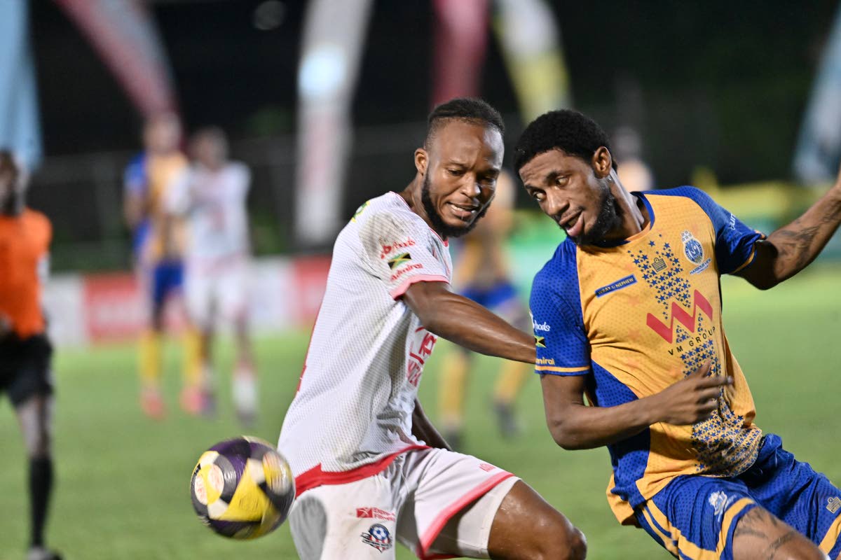 Forward Rohan Brown (right) of Harbour View and Portmore United’s defender Stephen Young battle for the ball during a Jamaica Premier League match in October.