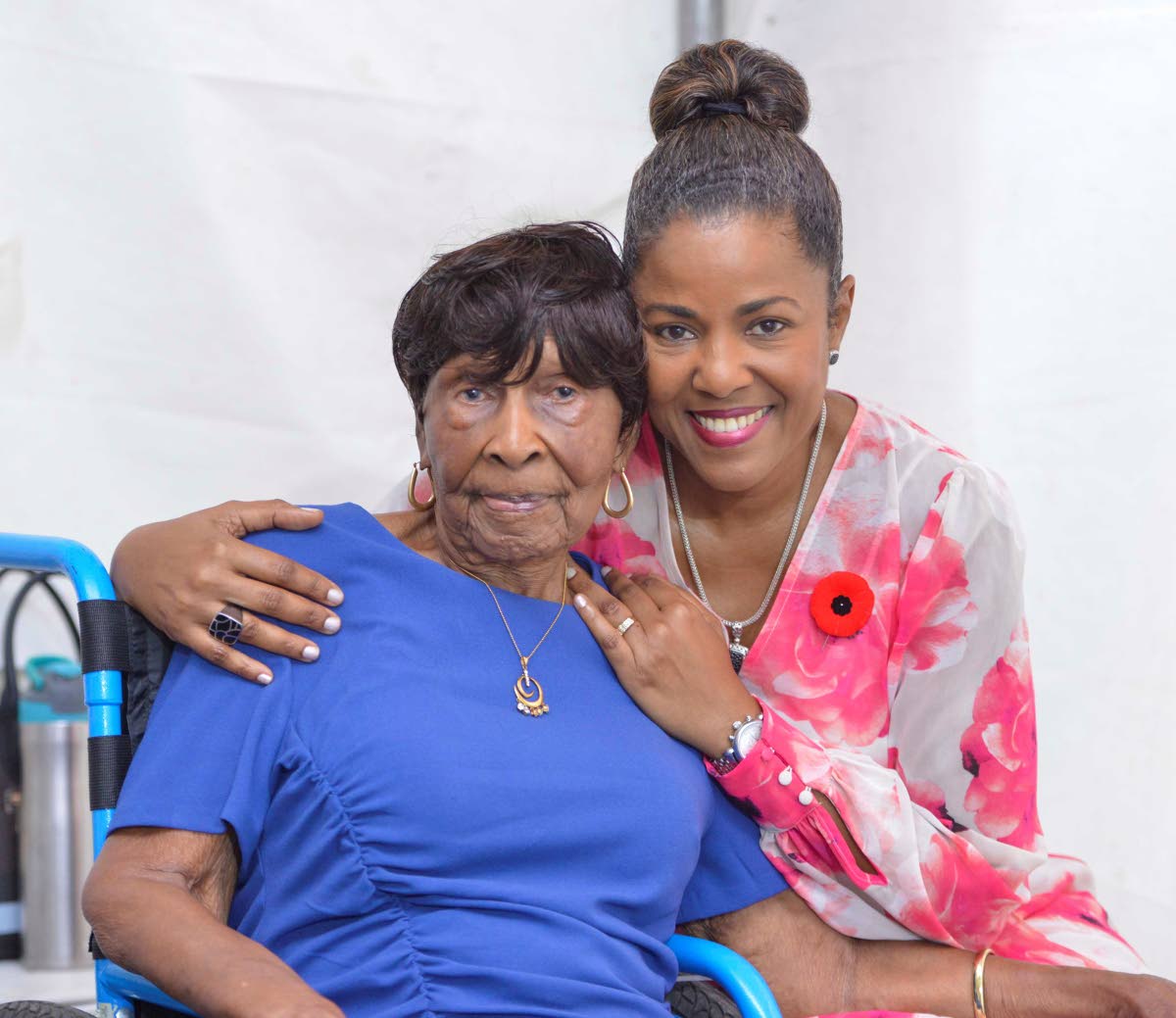 Centenarian Elsa Louise Atkinson is embraced by her daughter Michelle Williams, moments before receiving her Badge of Honour for 60 years of  service in the field of pharmacy.