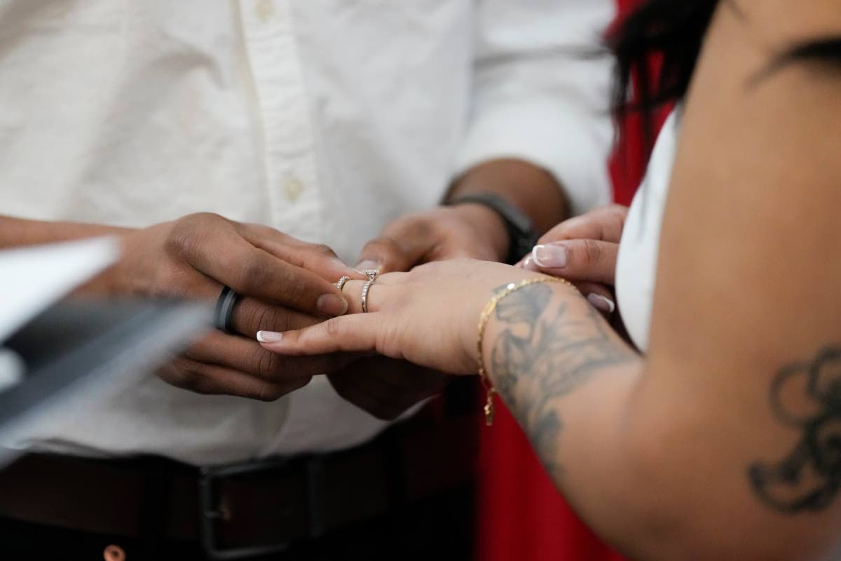 CENTRE LEFT: A groom places a ring on the finger of the bride during their Valentines Day wedding ceremony in Nashville, Tennessee, earlier this year.