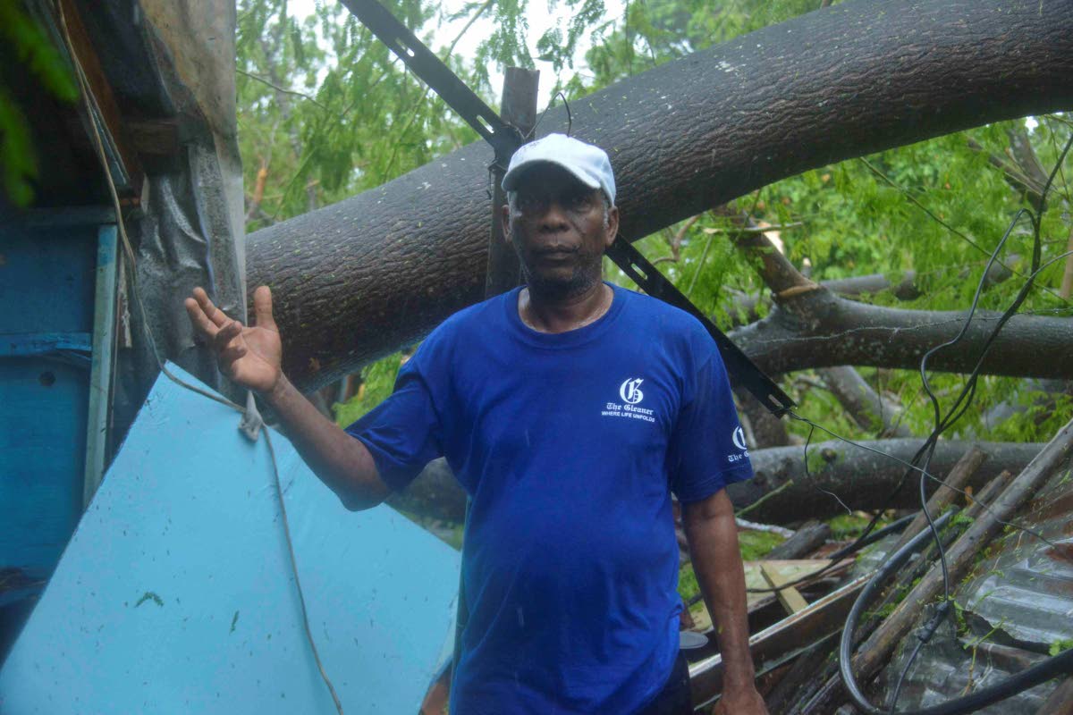 Clive Evans explains the extent of the damage to his house after Hurricane Melissa hit the island on Tuesday.