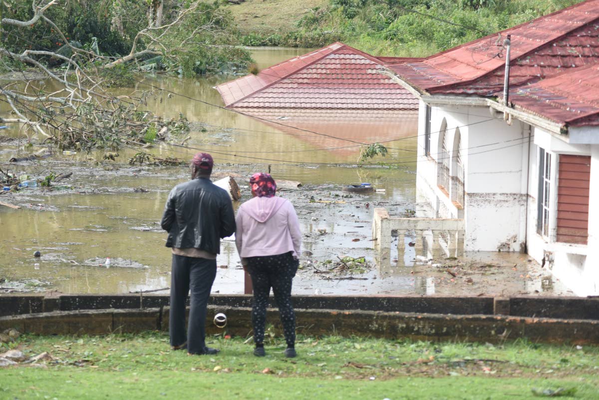 Houses and vehicles are seen submerged at Gibson Close, off Ward Avenue in Mandeville, following Hurricane Melissa.