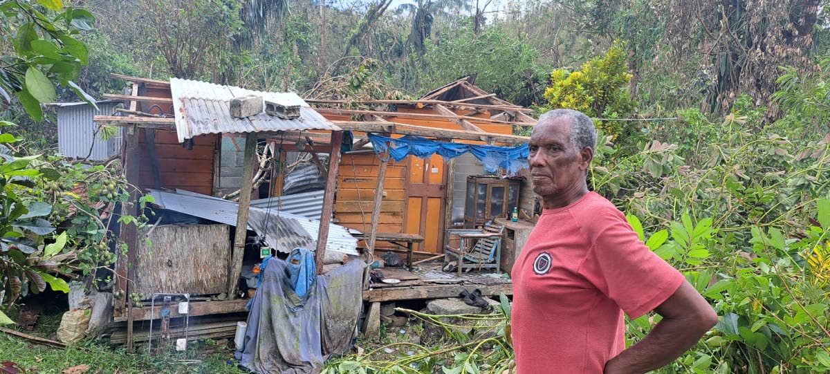 Billcon Phillips surveys the damage to his home in Comfort Castle, Portland, on Thursday, following Hurricane Melissa.