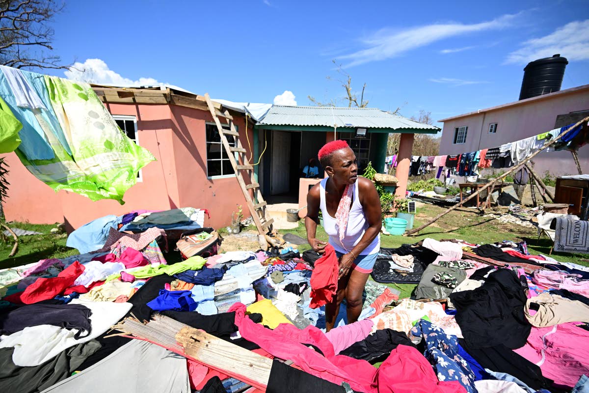 Gladstone Taylor/Multimedia Photo Editor 
Parnice Morrise of Pond Side, Black River St Elizabeth stands among the debris of what used to be her shop. She lost the roof of her house too.