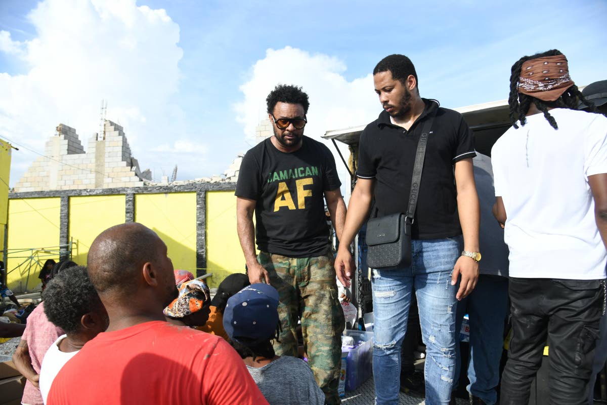 Shaggy (left) provides care packages to residents of St Elizabeth on Crane Road in the parish on Friday, October 31.