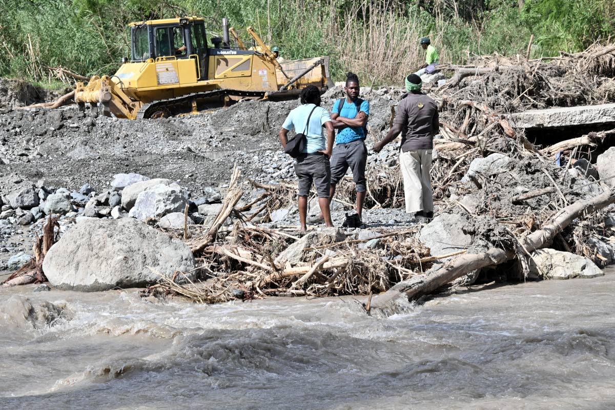 Workmen trying to restore vehicular or pedestrian access stop to assess the situation.