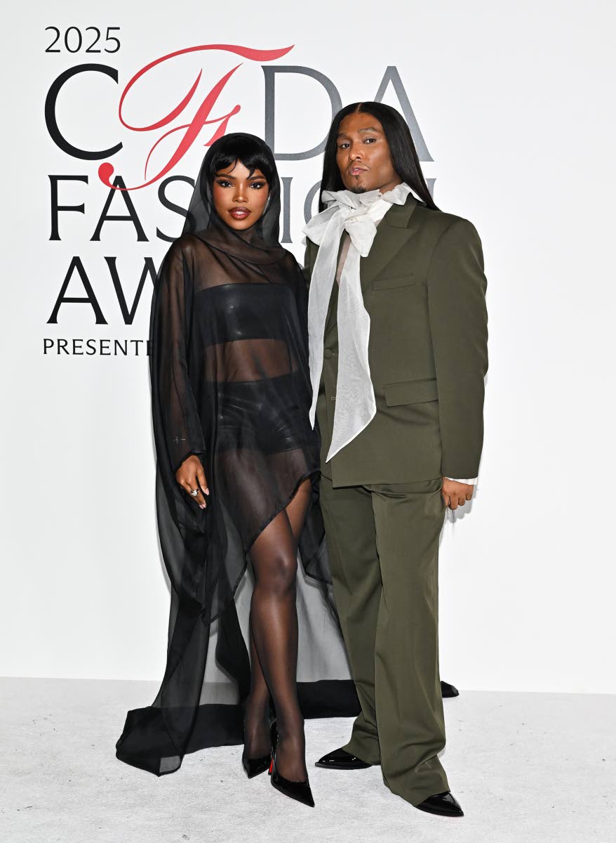 Ryan Destiny appears with her stylist Law Roach, donning a full black look with a dramatic sheer cape.