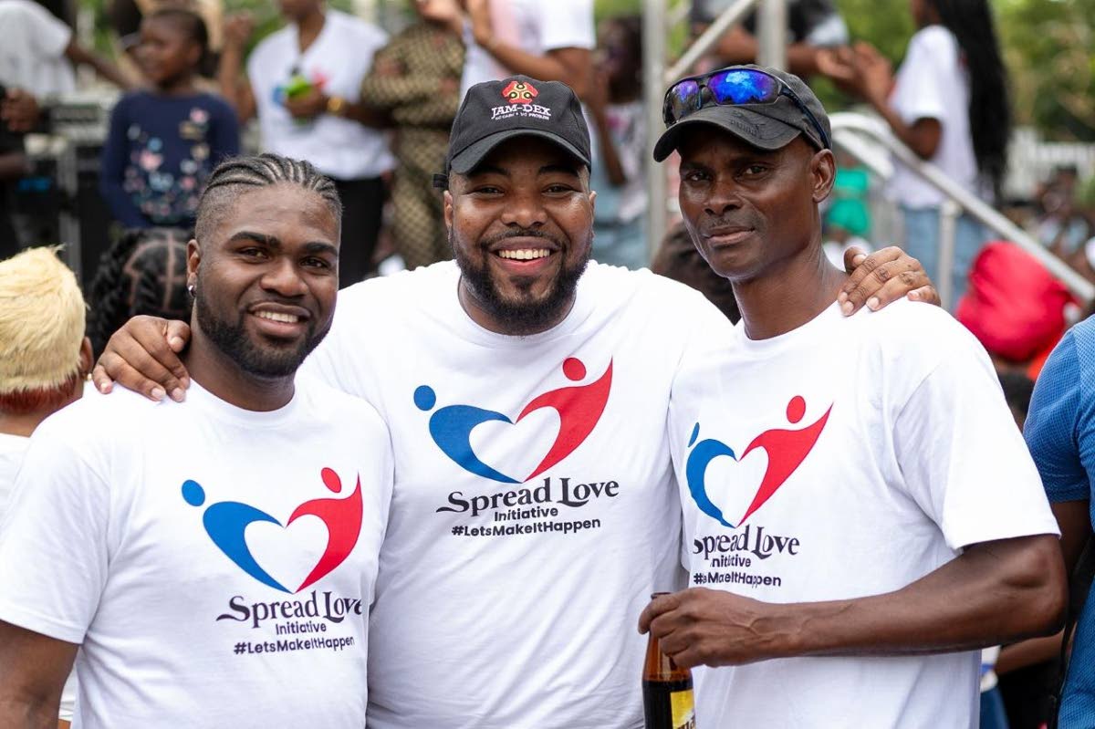 Rajae Danvers (centre), founder and executive director of the Spread Love Initiative, stands proudly with leaders in the community, Garrett Cooper (left) and Peter Nash.