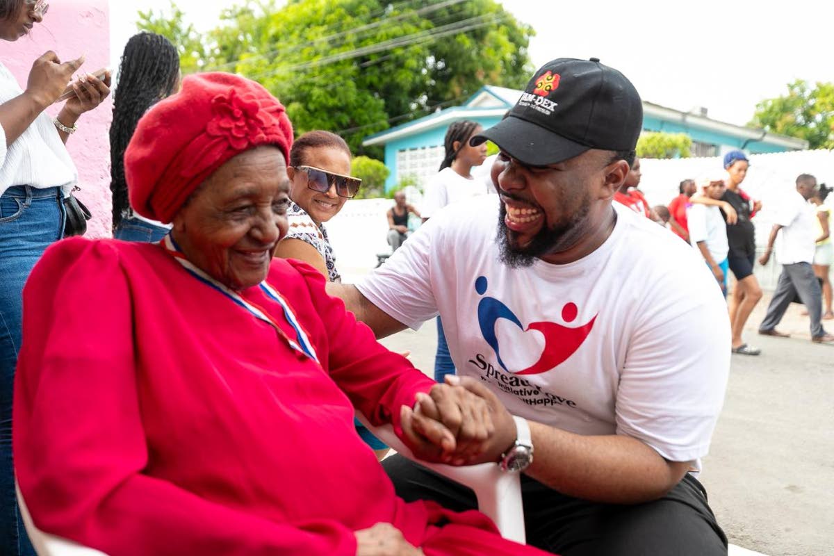 Rajae Danvers, founder and executive director of the Spread Love Initiative, engages with a community member during last year’s Christmas treat on Maxfield Avenue.