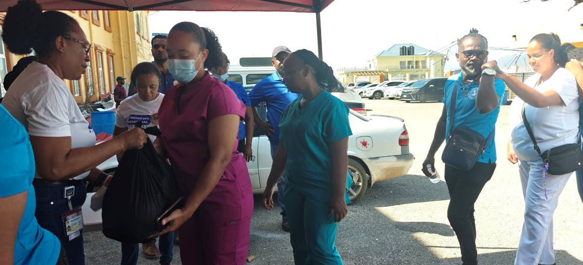 The Black River Hospital workers collect their care packages during Andrews Memorial Hospital’s outreach on Tuesday. The workers also received a hot meal during the special care event.