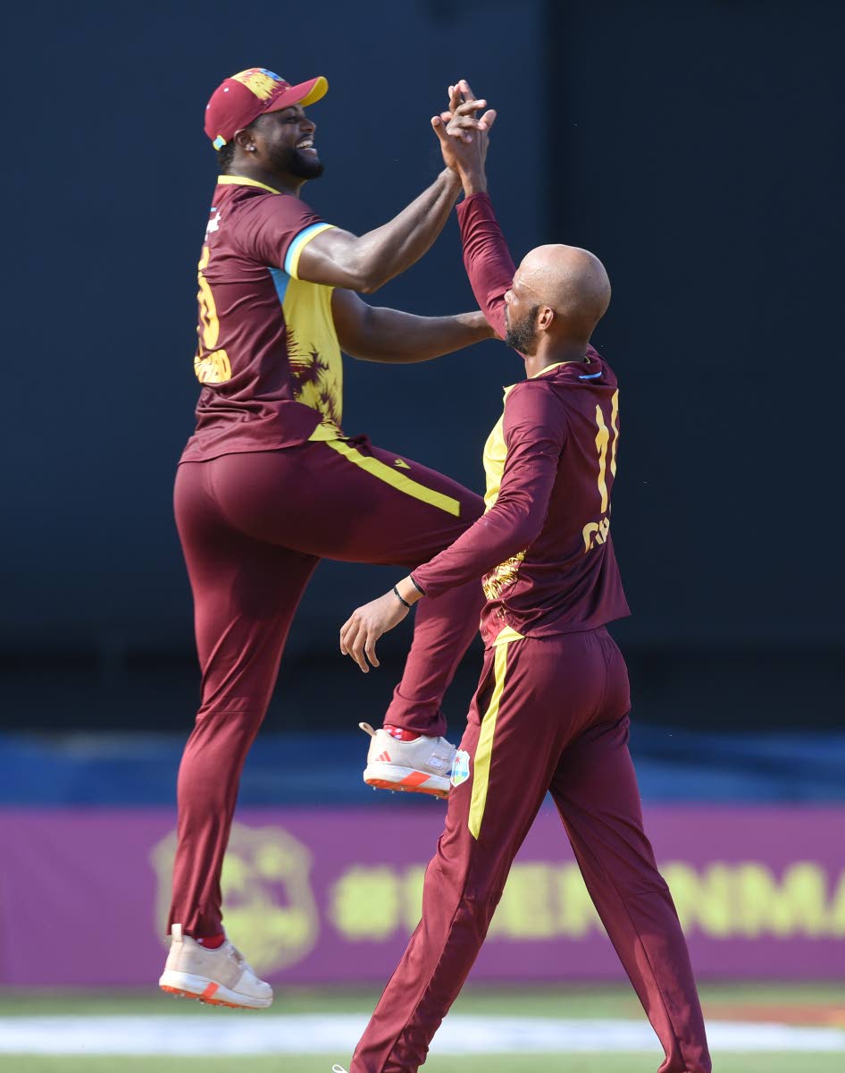 Romario Shepherd (left) and Roston Chase celebrate during a 2024 T20 series against South Africa at Sabina Park. 
