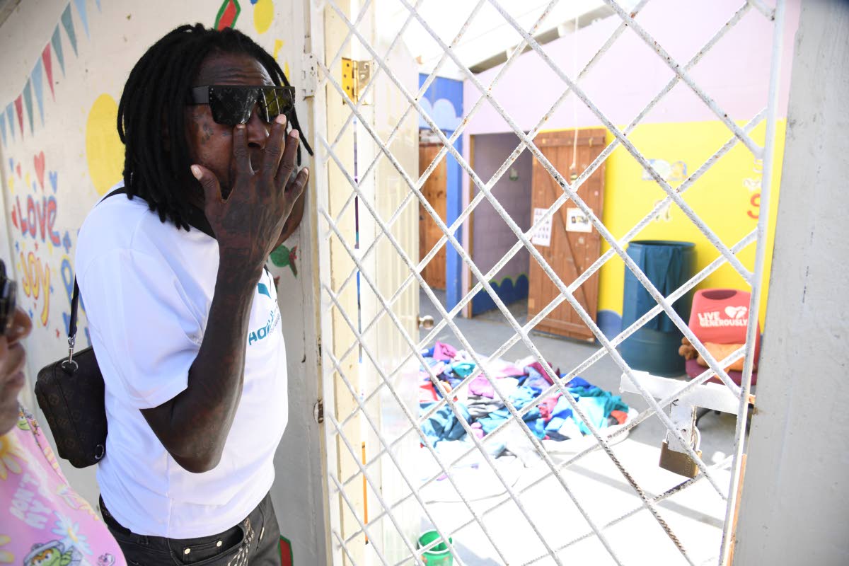 Dancehall artiste Vybz Kartel wipes tears as he tours sections of the Westhaven Children’s Home in Hanover.
