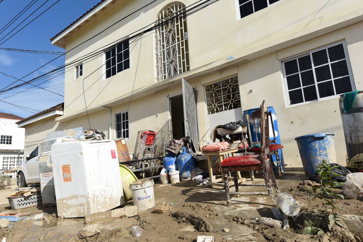 
Residents of Westgreen put out items to dry a week after their homes were flooded during the passage of Hurricane Melissa.