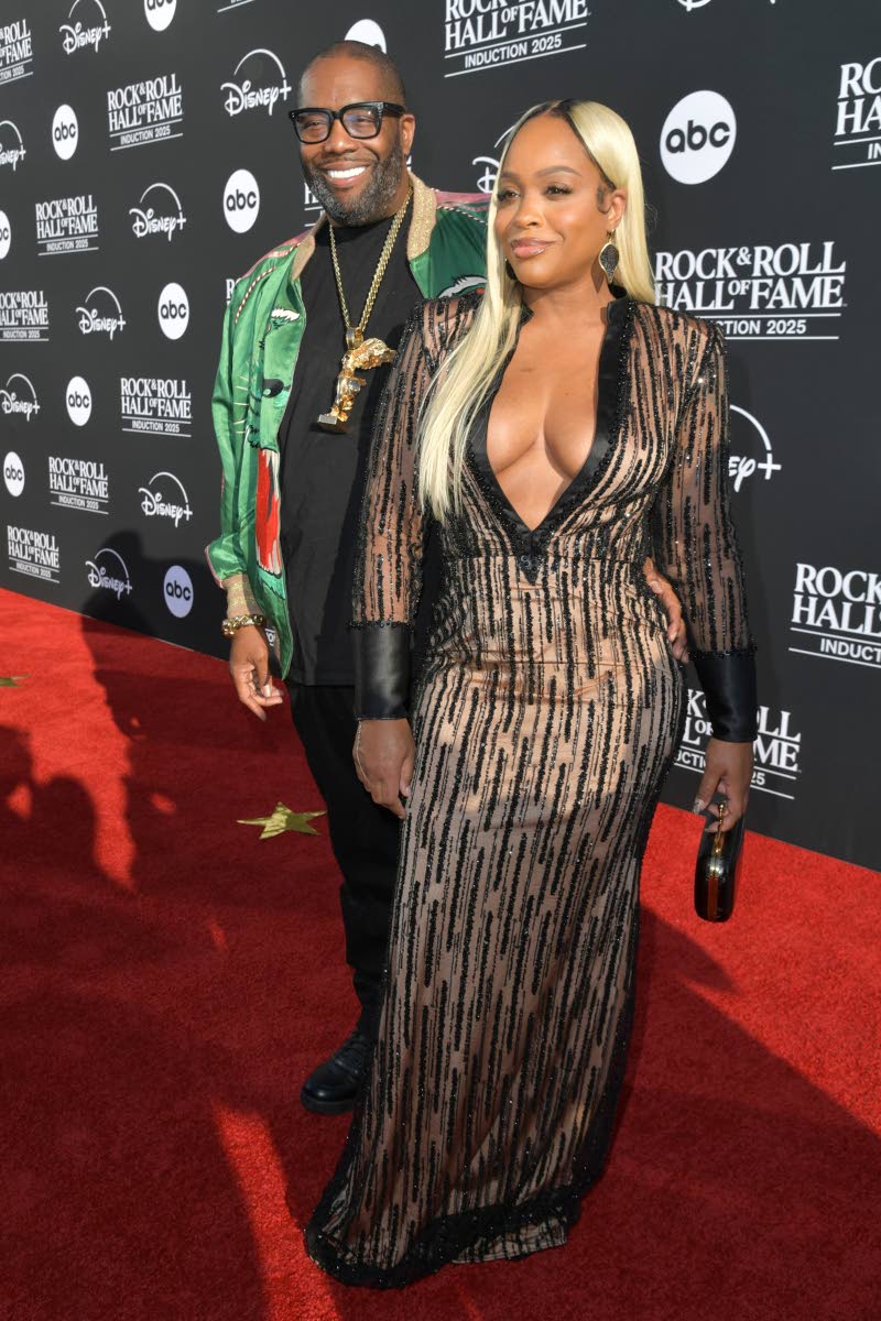 Killer Mike (left) and Shay Render walk the red carpet, Render in a plunging sequined gown. 