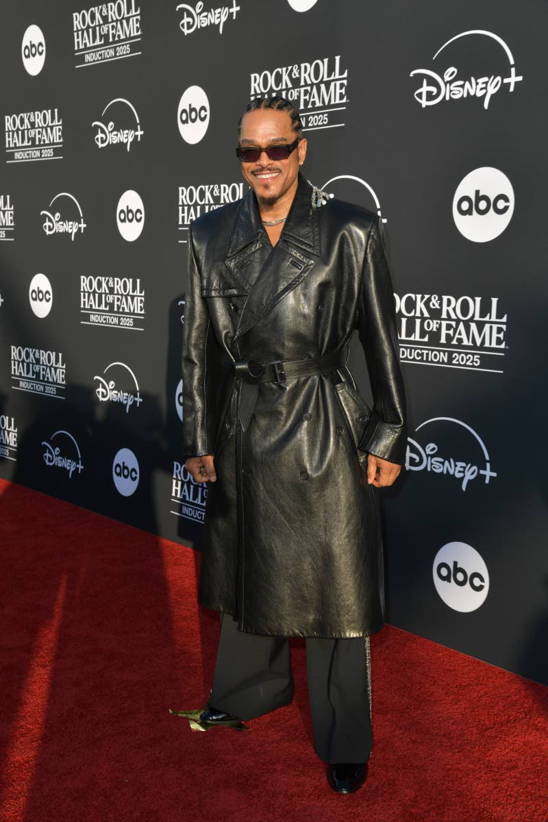 Maxwell dons a leather trench, pairing it with black pants with bejewelled stripes.