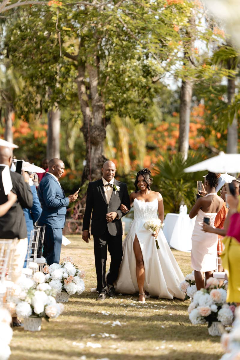 All eyes turned as Kamille made her entrance on her father Alrick Griffiths’ arm.