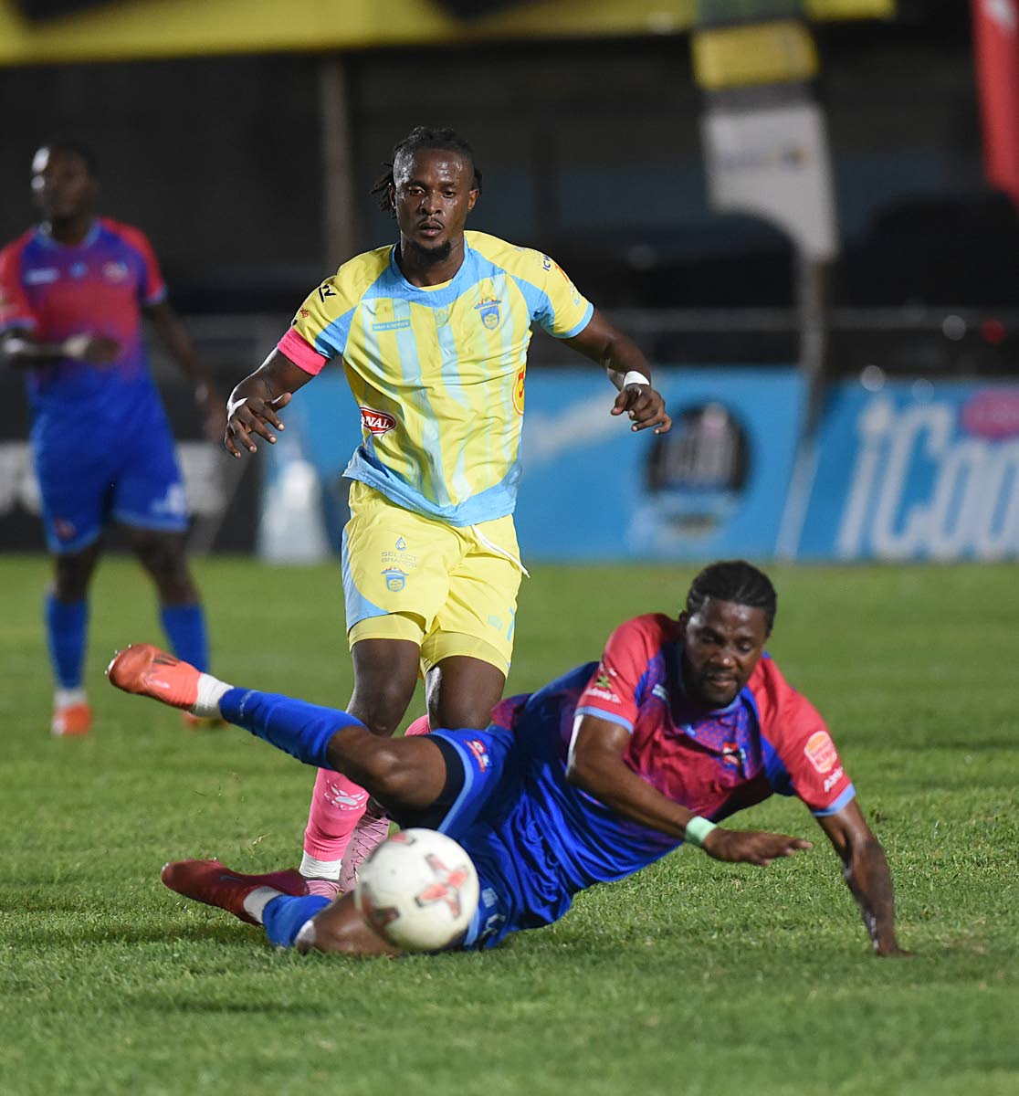 Dunbeholden FC’s Nevaun Turner (right) hits the turn during a clash with Waterhousee’s Revaldo Mitchell during a Jamaica Premier League Game at Drewsland on October 19.