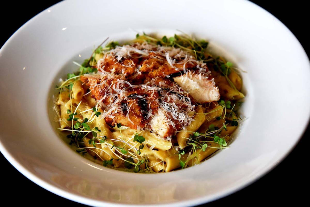 This island pasta showcases delightfully seasoned chicken breast served a top creamy jerk Alfredo.