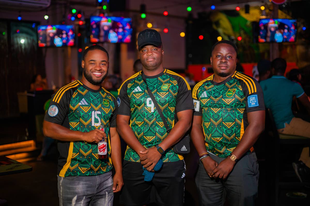 The camera snapped a trio of proud Jamaicans showing both team spirit and community pride (from left) Photographer Rishane Gunning, Reggae Boyz Community Director Kemo Hunter and Accountant Alrick Livingston. 