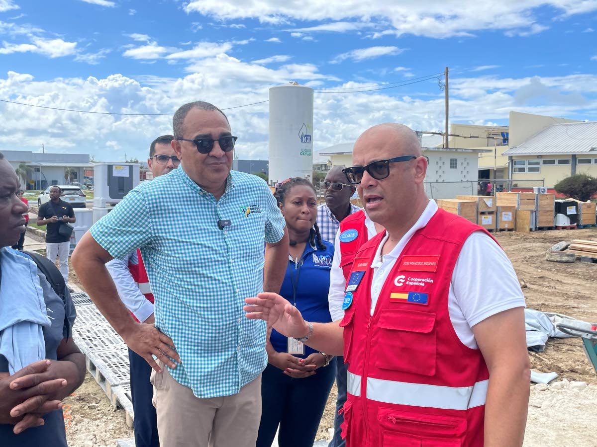 Dr Christopher Tufton (left) conversing with a member of the Spanish medical team.