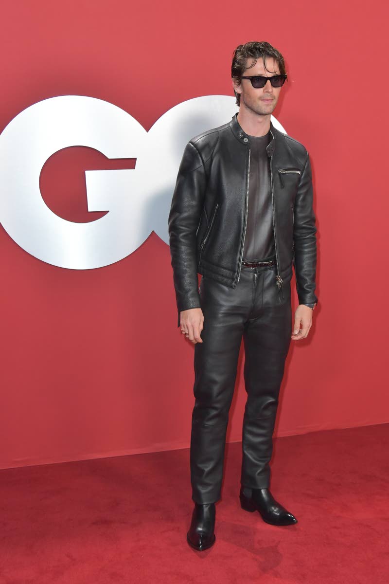 BELOW: Patrick Schwarzenegger shows off his cool style in a sharp leather moto set