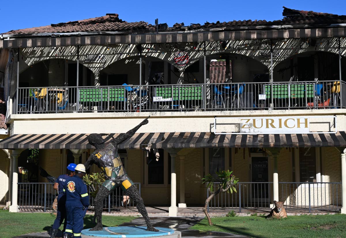 Firefighters at Usain Bolt’s Tracks & Records restaurant in Montego Bay, St James, following a blaze at the eatery on Saturday.