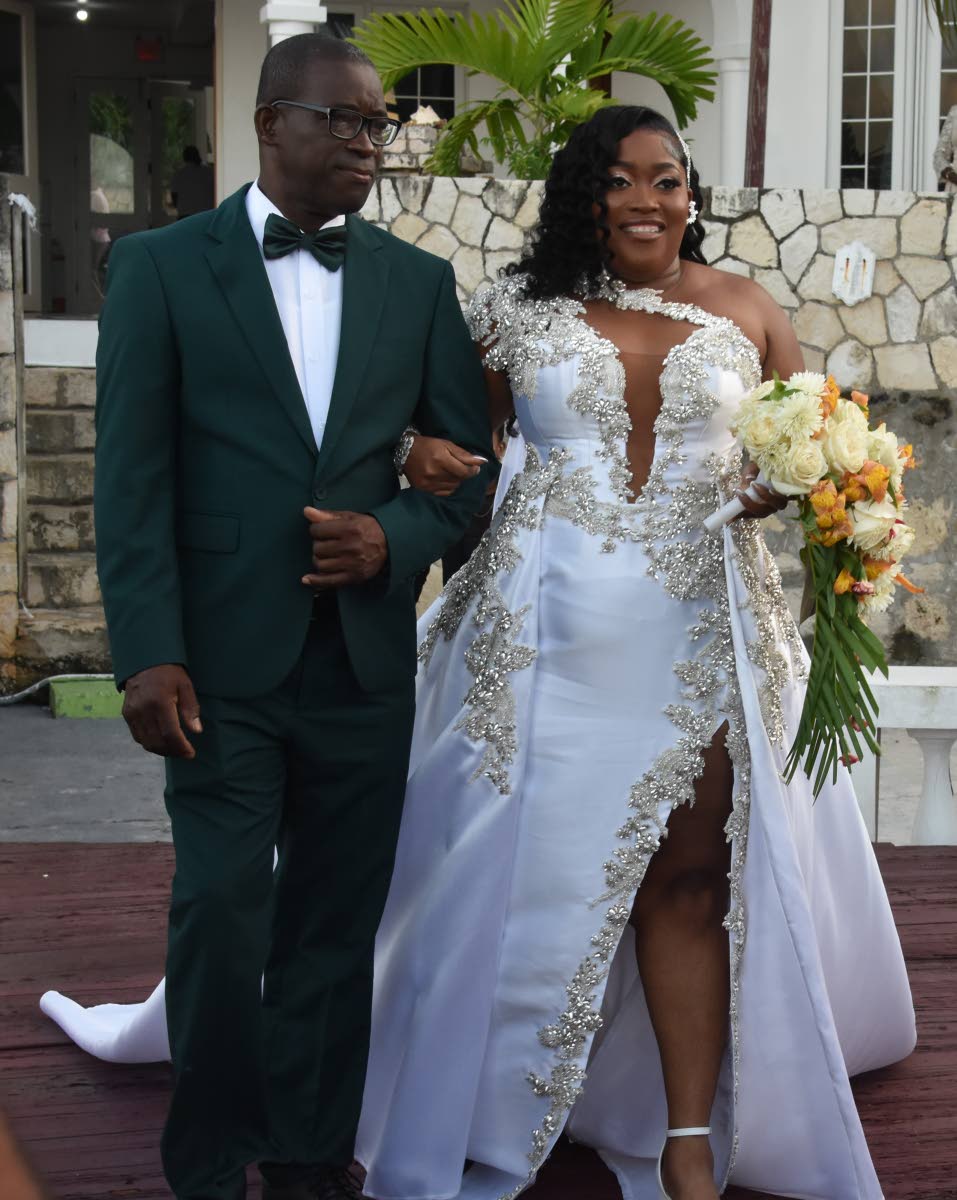 With pride and love, Jordine is escorted down the aisle by her father, Sean McKenzie.