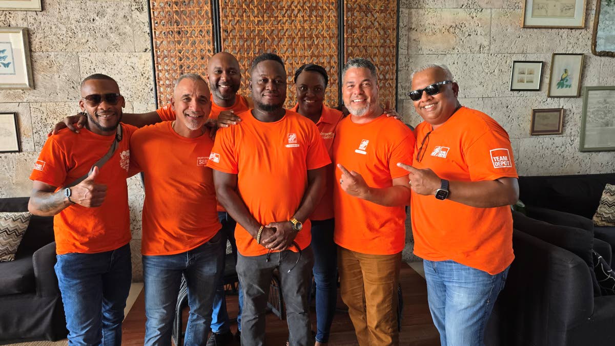 Home Depots crew from Left:  Omar Sterling, Eddie Correa, Carnel White, Warren Cork and Anand Singh. Back from left: Damian Brown and Tayone Welsh share lens time in the lobby of the S Hotel Montego Bay.